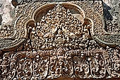 Banteay Srei temple - second enclosure, portico of the east gopura, a thick-breasted deity sits by two elephants with upraised trunks 
